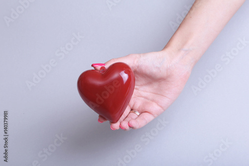 Female doctor hold in hands red heart . Cardio therapeutist  student education  arrhythmia concept