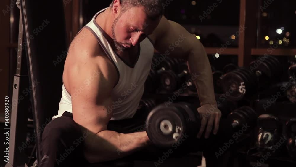 Muscular man exercising in fitness club Muscular man exercising in fitness club
