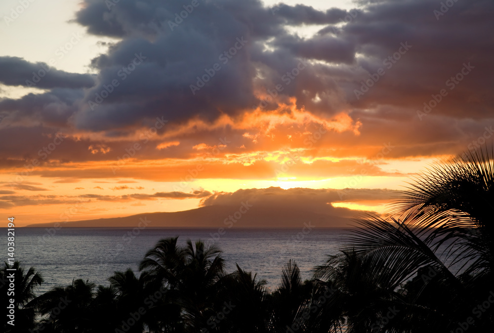 Sunset across distant island (Lanai) from Maui