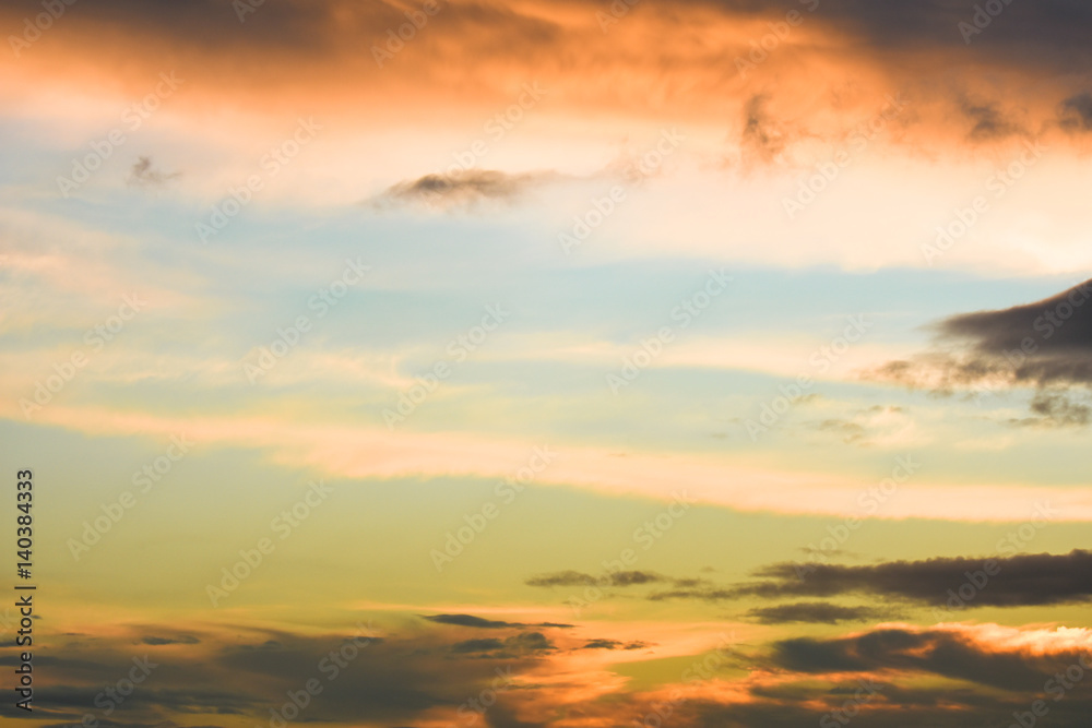 Blue sky between orange clouds. Sunset with clouds.