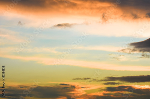 Blue sky between orange clouds. Sunset with clouds. © oralz