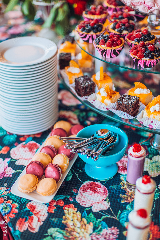 Delicious sweets on candy buffet. Lot of colorful desserts on table. Delicious sweets on candy buffet. Lot of colorful desserts on table.