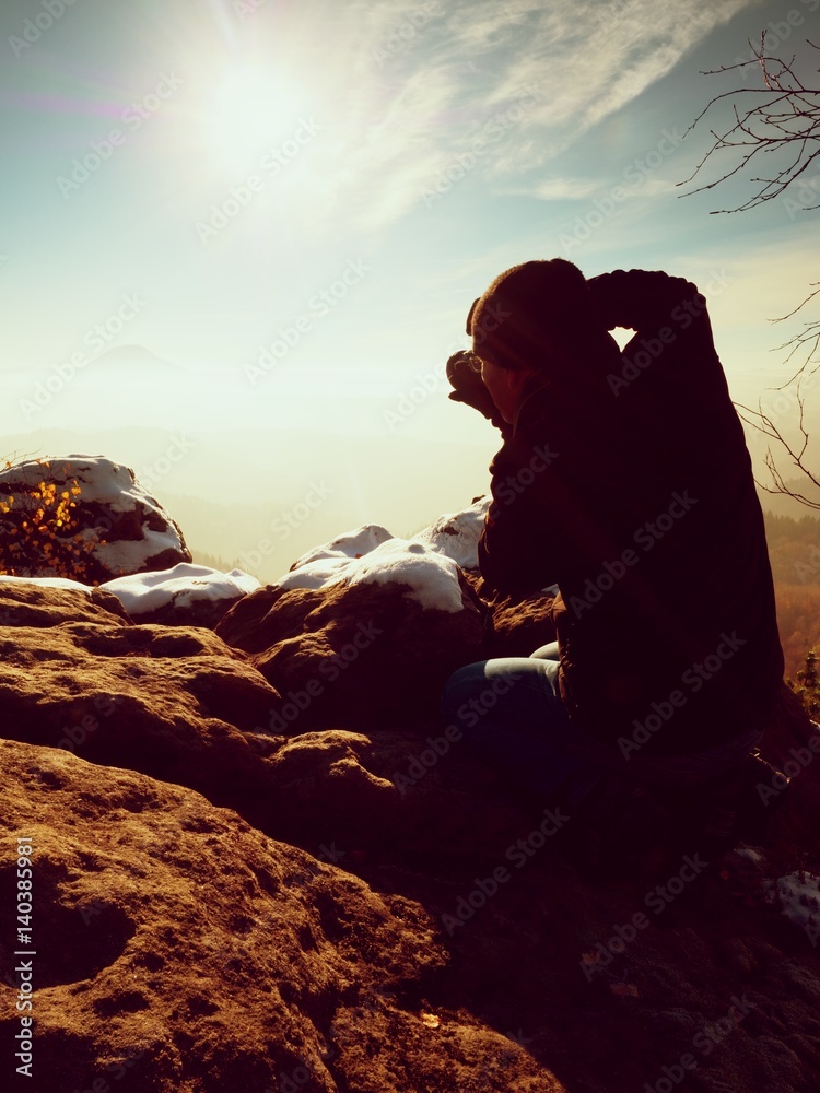 Fototapeta premium Man photographer takes picture. Marvelous freeze autumn
