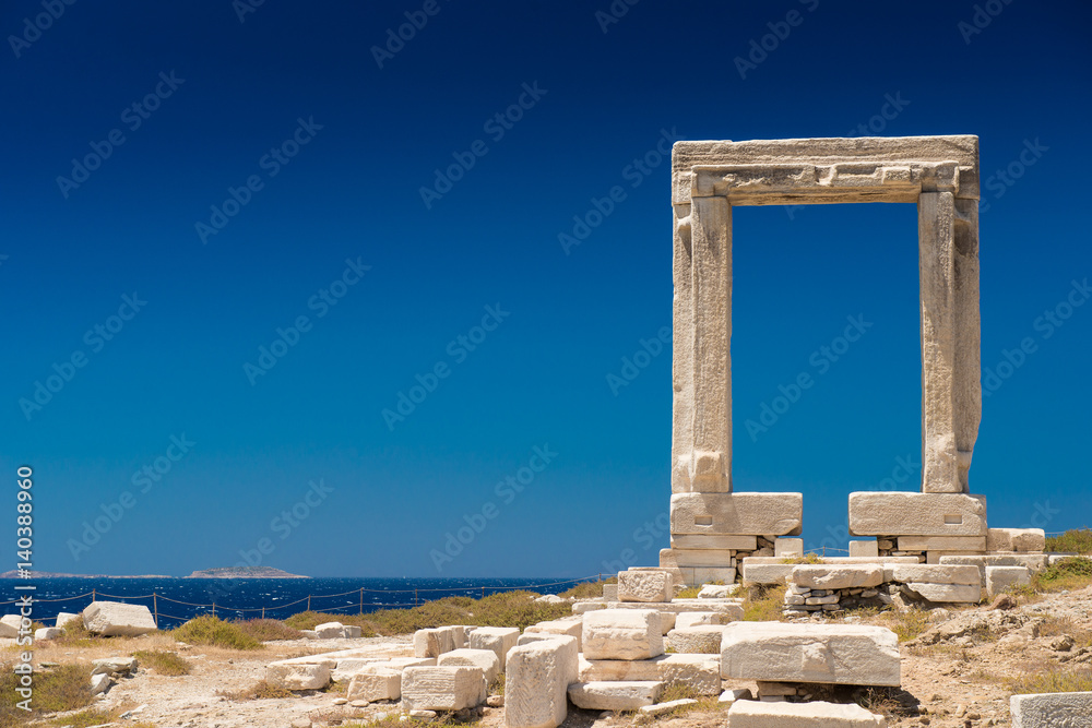 Apollo Temple entrance, Naxos island, Cyclades. Seascape of the island of Naxos, Greece. The most famous Greek view. famous Gate on the island of Naxos. Arch of the Ancient Temple


