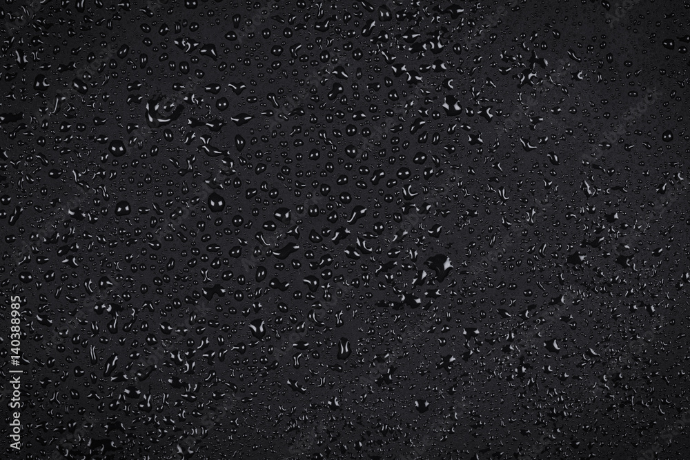 Water drops on dark stone Water drops on dark stone