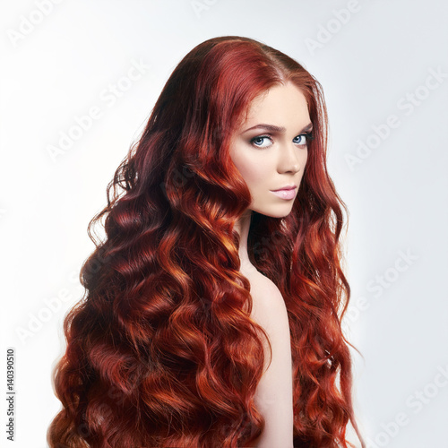 Sexy nude beautiful redhead girl with long hair. Perfect woman portrait on light background. Gorgeous hair and deep eyes. Natural beauty, clean skin, facial care and hair. Strong and thick hair