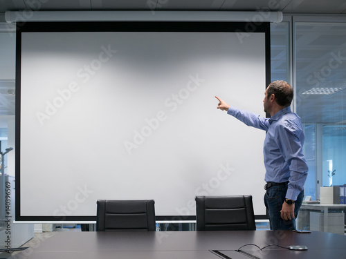 Manager explains at projection screen photo