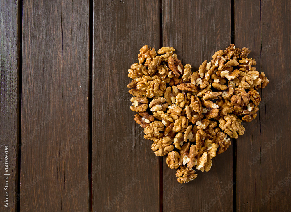 heart made of walnuts on wooden surface heart made of walnuts on wooden surface