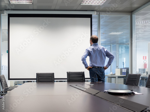 Manager looks at projection screen