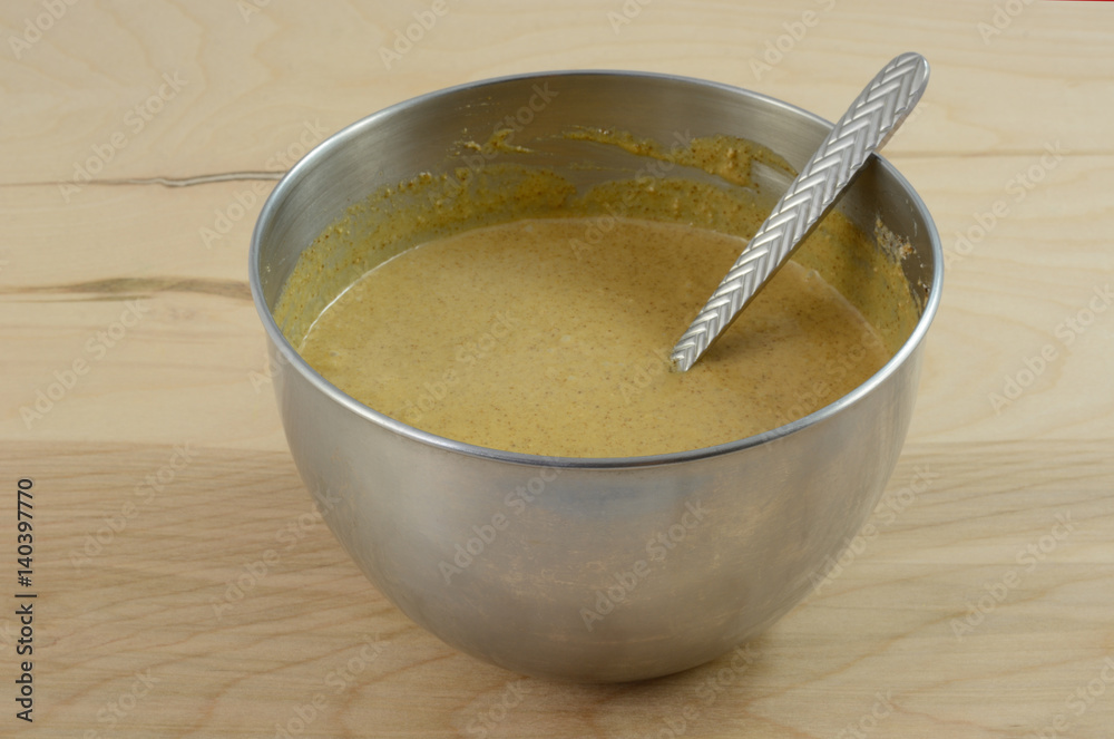 Mixing up gingerbread dough in stainless mixing bowl Mixing up gingerbread dough in stainless mixing bowl