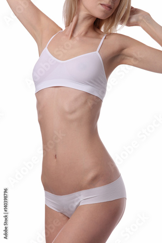 Beautiful slim woman wearing white underwear isolated. Perfect Slim Body, waist, belly, abdomen close up. Sport, fitness, Dieting results. Waxing, laser hair removal treatment.