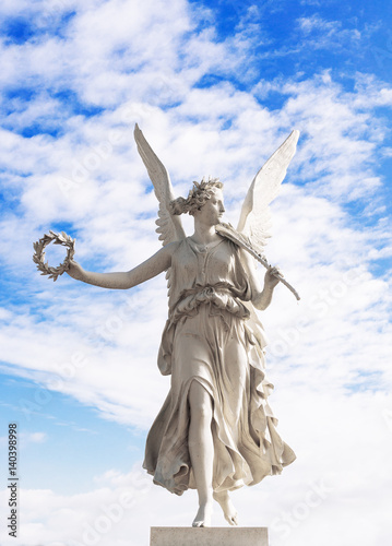 Принти на полотні Statue of the goddes Nike, blue sky and clouds