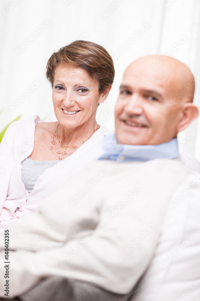 Happy middle-aged couple relaxing at home Happy middle-aged couple relaxing at home