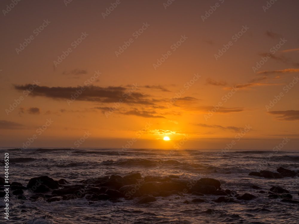 Sunrise on eastern shore of Kauai in Lydgate State park.