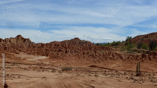 Landscape view of dark red fragile soil that's been heavily eroded in the Tatacoa desert in Colombia.