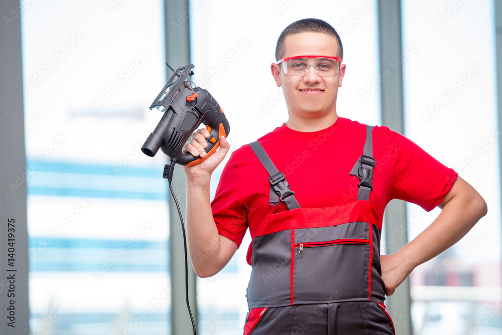 Young furniture carpenter in industrial concept Young furniture carpenter in industrial concept