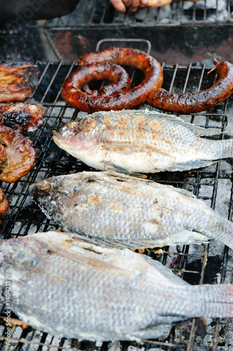 Salt-Crusted Grilled Fish,Thai dessert,street food. In Thailand it is a standard food of the northern provinces and it has become very popular in the rest of Thailand as well. © ponsulak