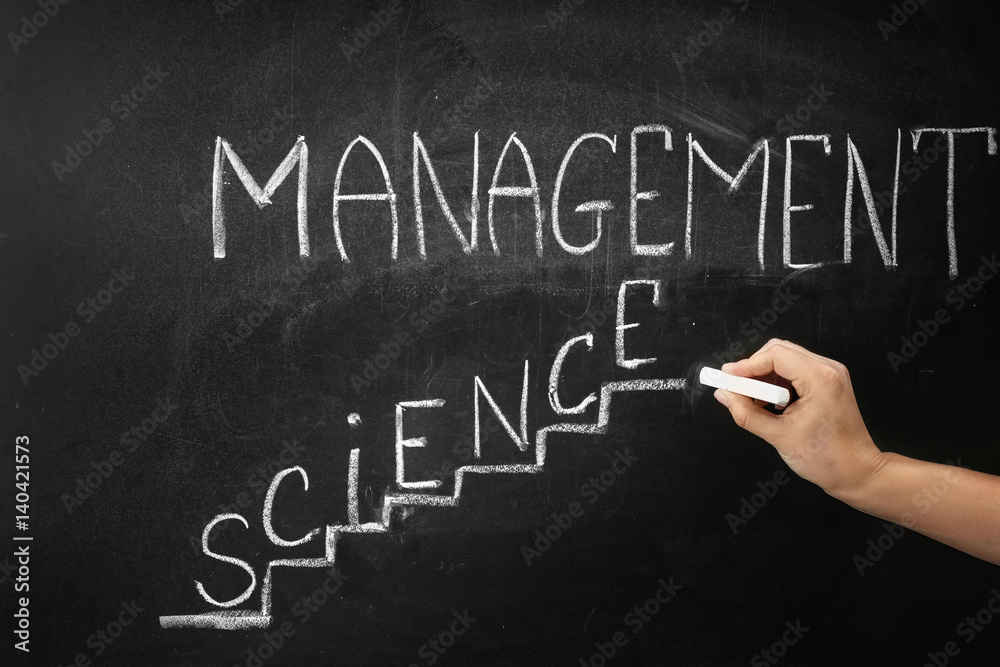Hand writing phrase MANAGEMENT SCIENCE on blackboard Hand writing phrase MANAGEMENT SCIENCE on blackboard