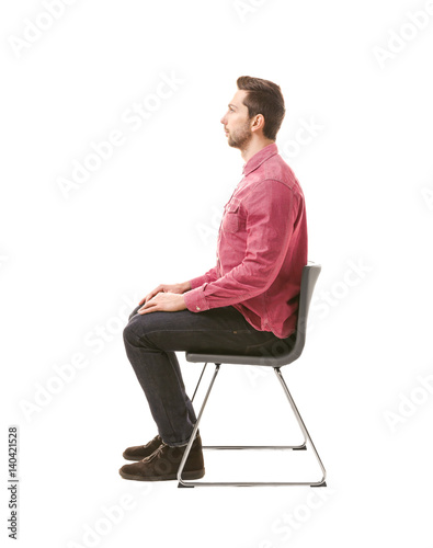 Incorrect posture concept. Man sitting on chair isolated on white