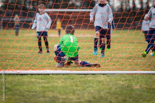 Young soccer goalie making a save