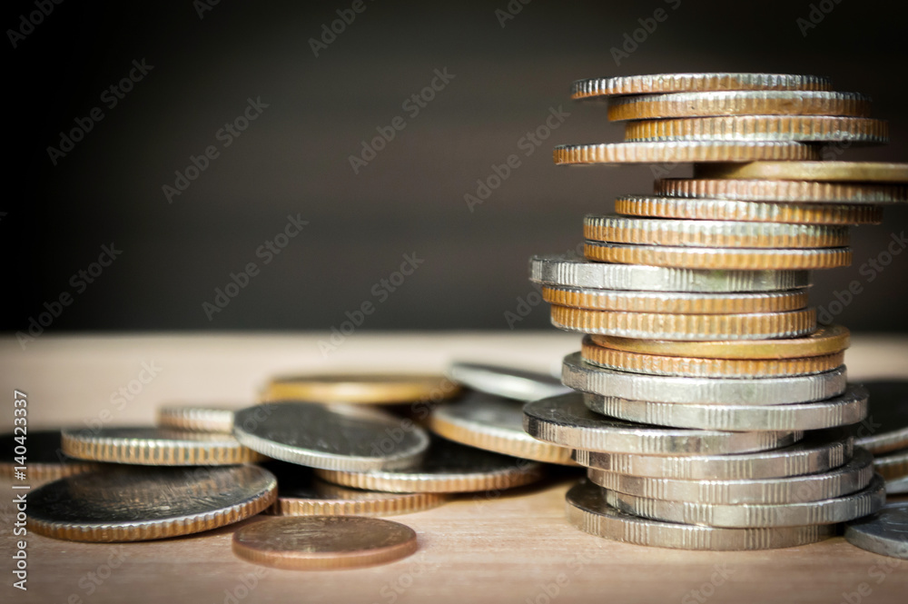 Coins stacked on each other in different positions, Finance and business concept, Selected focus, Abstract background. (Macro with blur and soft focus, low light) Coins stacked on each other in different positions, Finance and business concept, Selected focus, Abstract background. (Macro with blur and soft focus, low light)