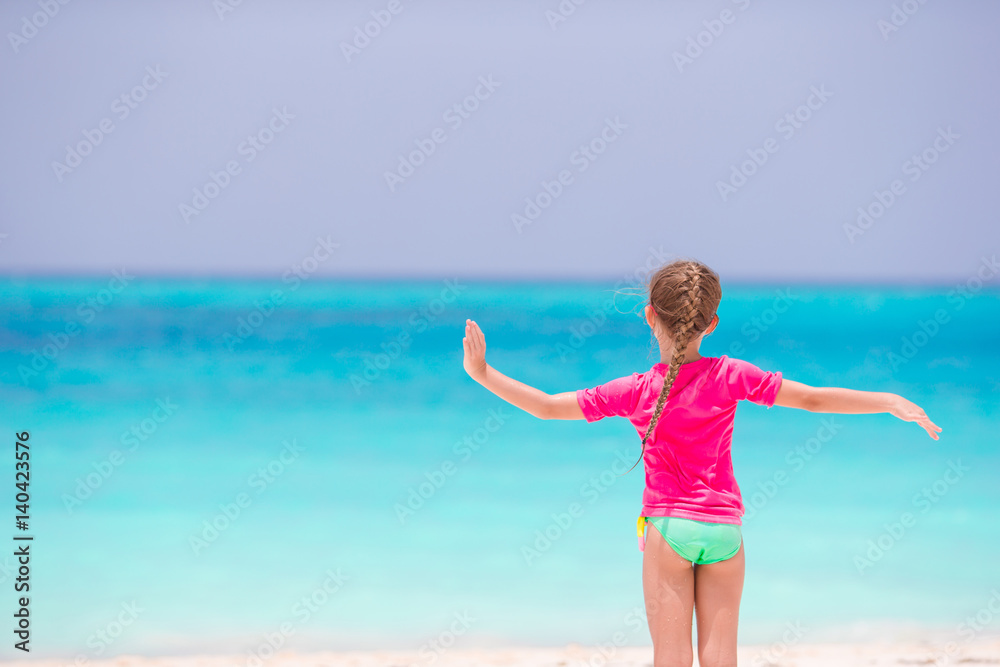 Adorable little girl at beach during summer vacation Adorable little girl at beach during summer vacation