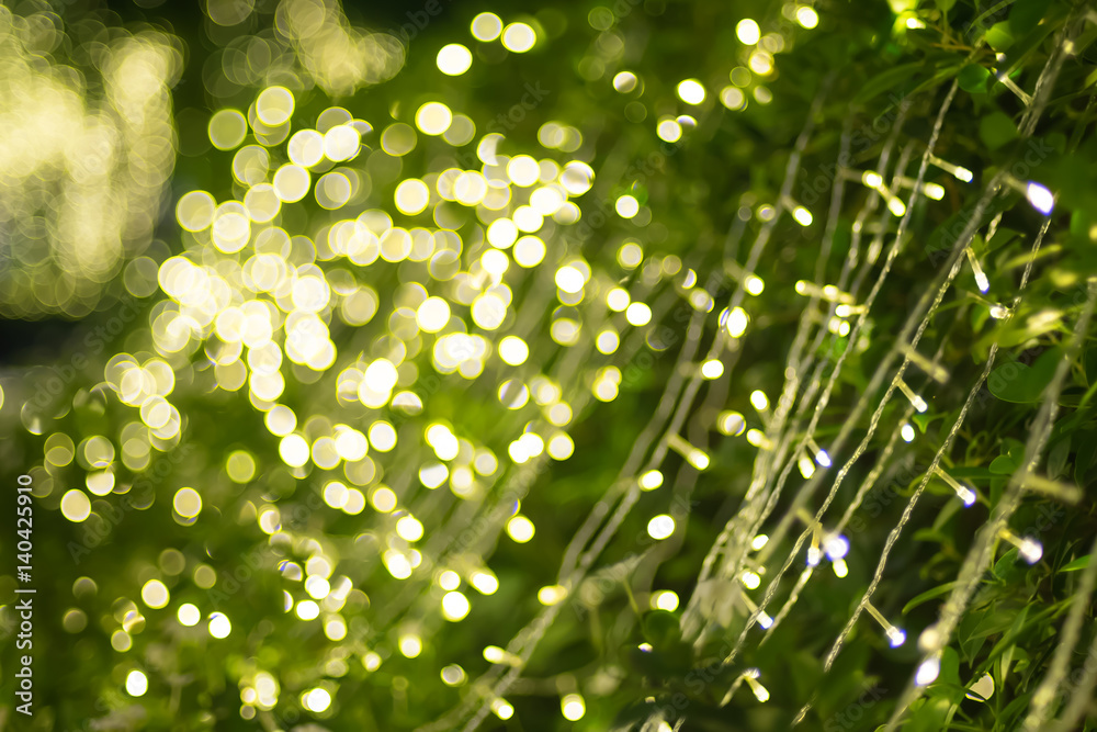 Blurred background of green tree decoration with light bokeh