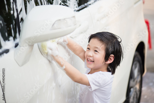 Asian children washing car