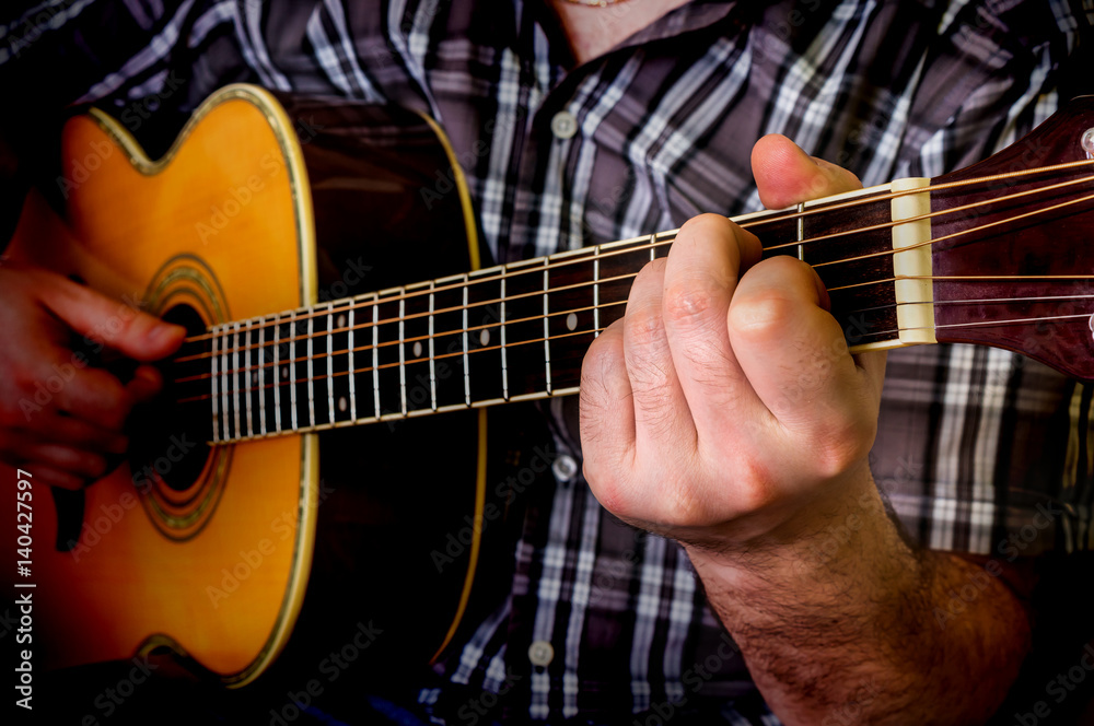 Fototapeta premium Man playing acoustic guitar