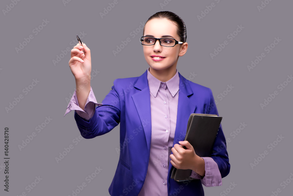 Businesswoman pressing virtual button with pen Businesswoman pressing virtual button with pen