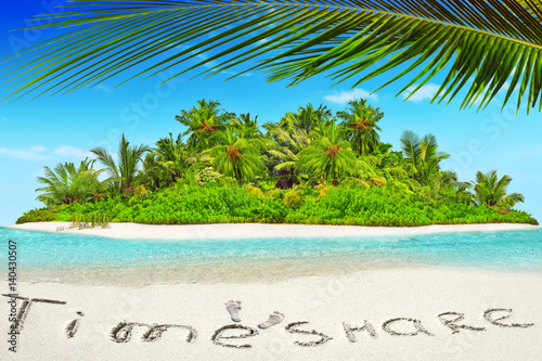 Whole tropical island within atoll in tropical Ocean and inscription 