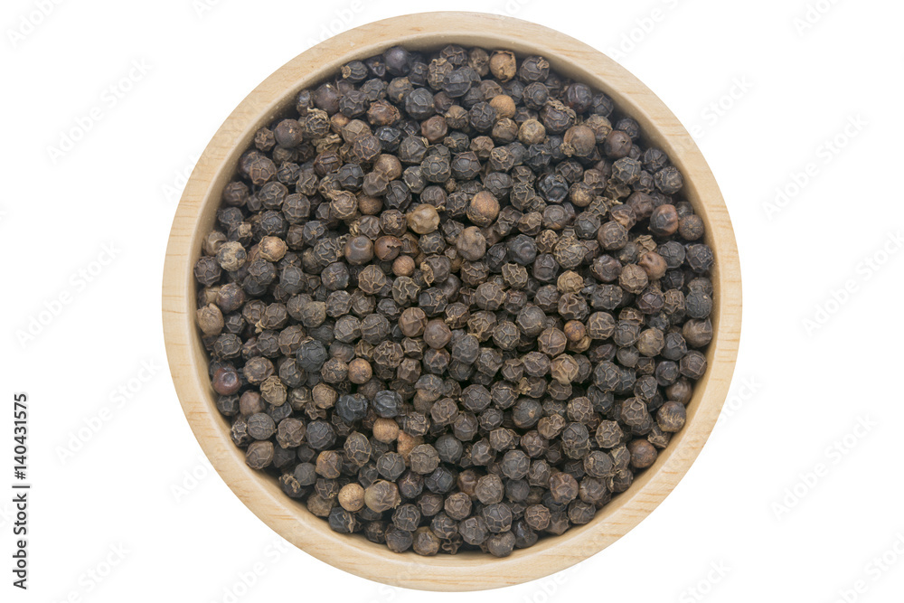 Black peppercorns in wooden bowl isolated top view on white Black peppercorns in wooden bowl isolated top view on white