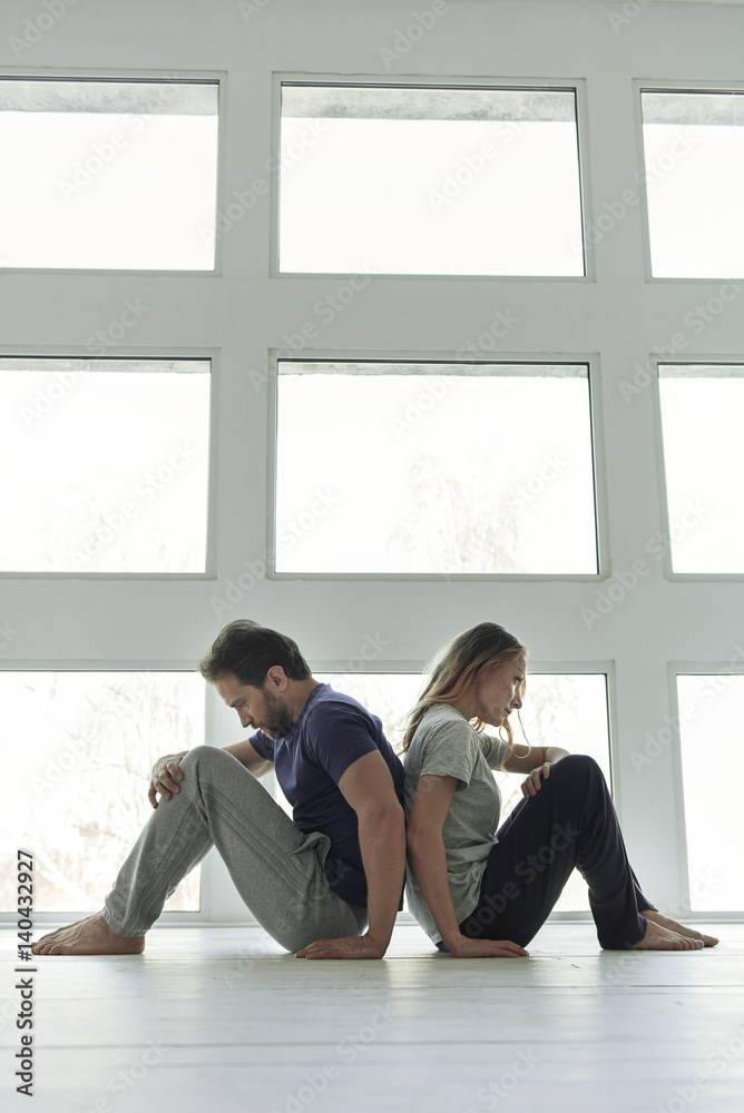 Fototapeta premium Frustrated couple sitting near window