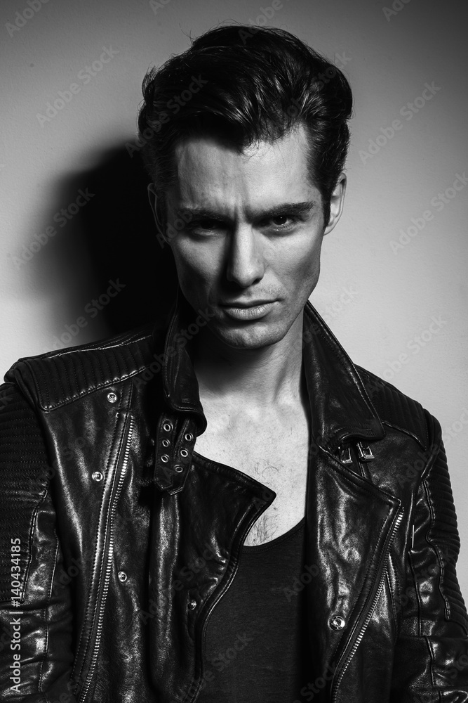 Obraz premium black and white portrait of young man in leather jacket