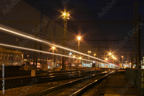 Train with strong light on long exposure in main station.