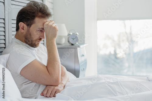 Fotografie Thoughtful guy suffers from insomnia