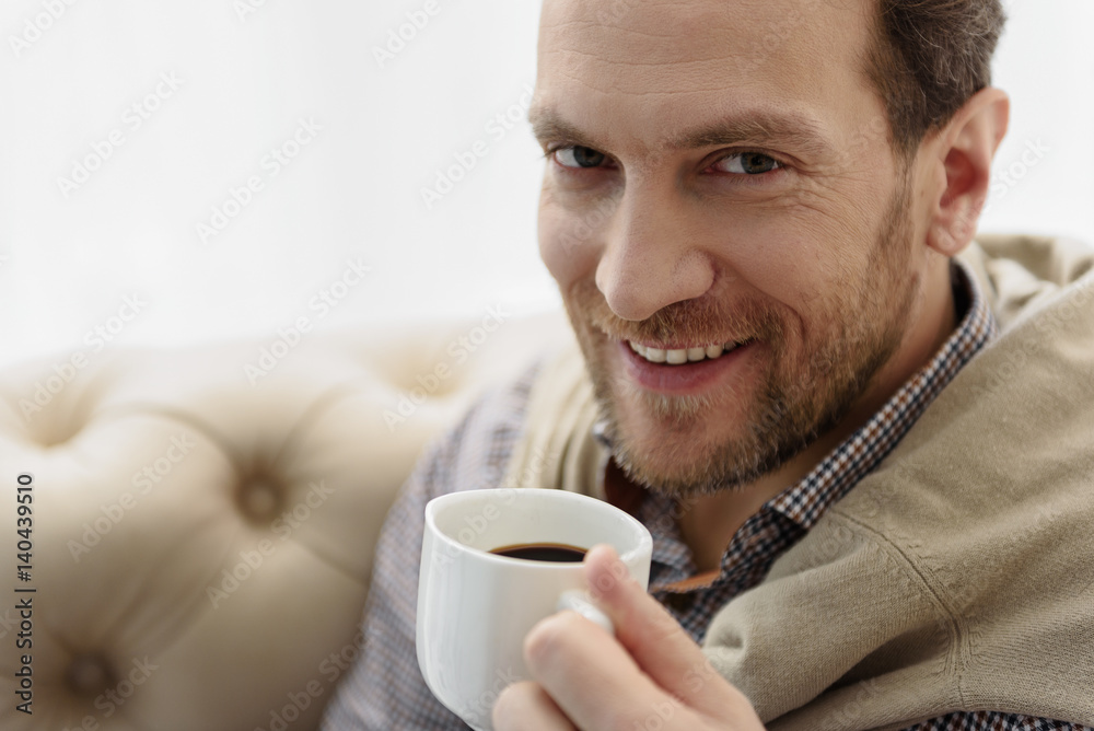 Cheerful guy enjoying hot drink Cheerful guy enjoying hot drink