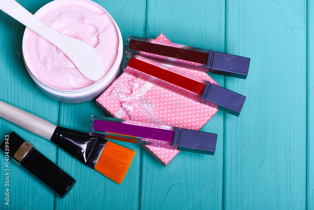 Naklejka premium various cosmetics: cream, lipsticks, brush, cosmetic spatula, present box