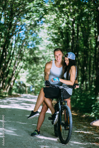 young lovers riding a bicycle, outdoor