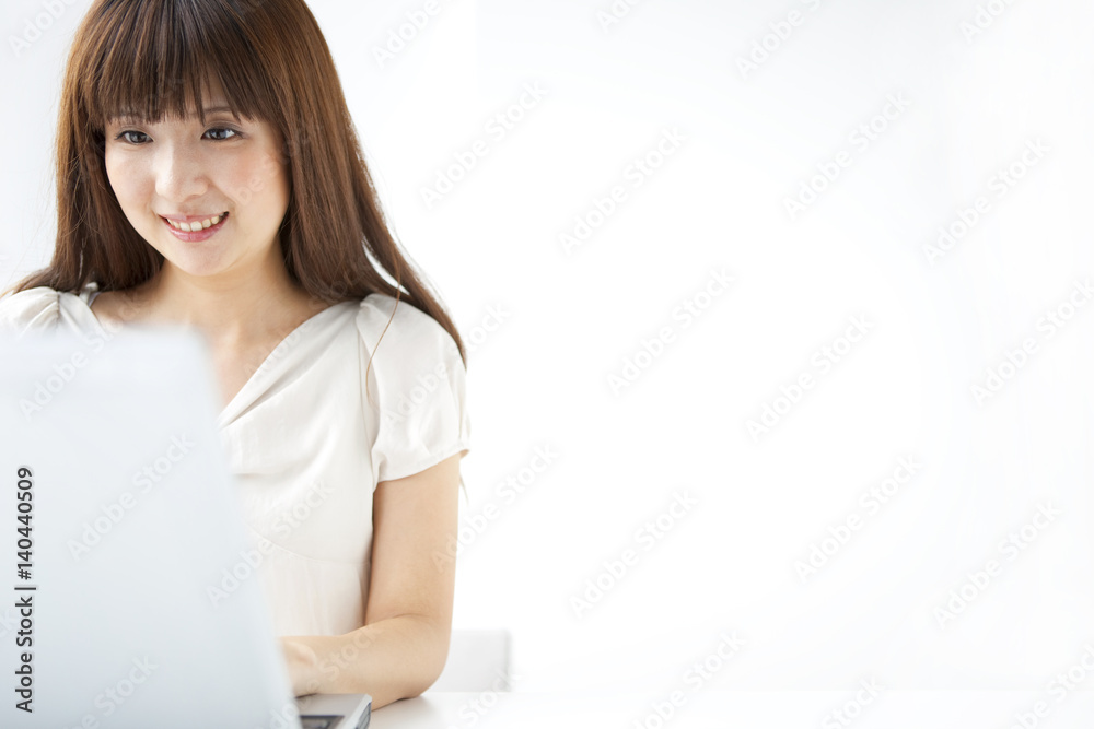 Young woman using laptop, white background, copy space Young woman using laptop, white background, copy space