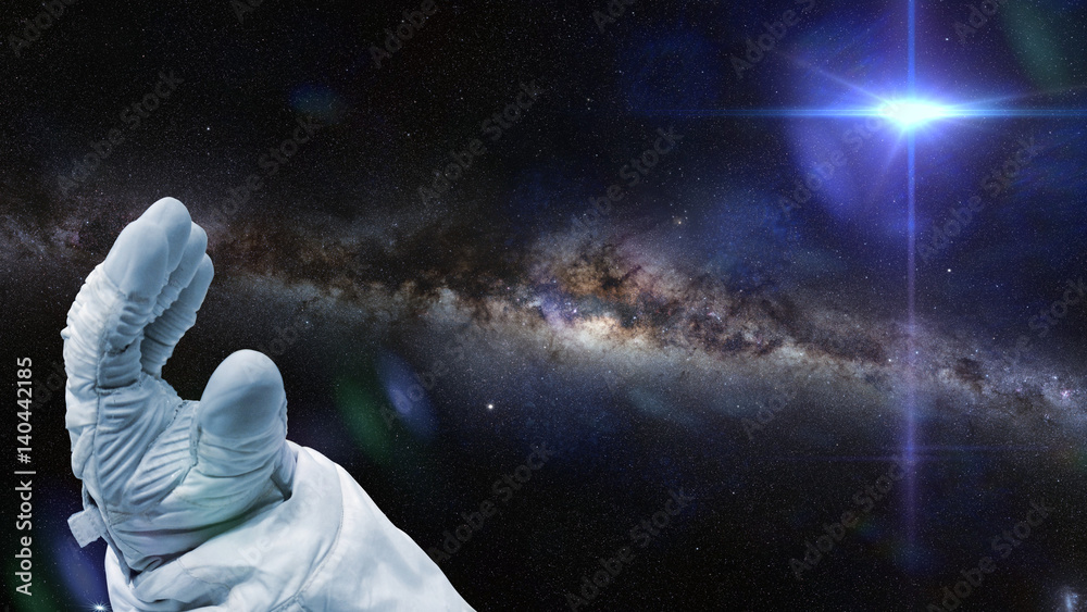 Fototapeta premium astronaut, bright nearby star and the local a galaxy