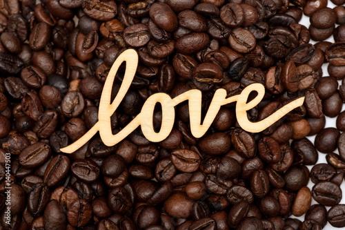 Coffee beans and wooden iscription of word love