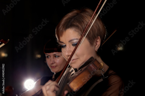 Musician play violin on dark