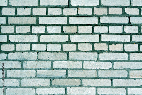 Cyan toned grungy brick wall pattern.