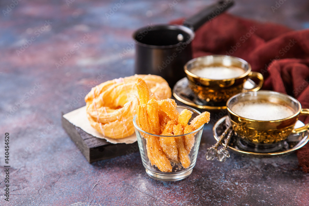Eclairs and coffee on a table. Selective focus. Copy space
