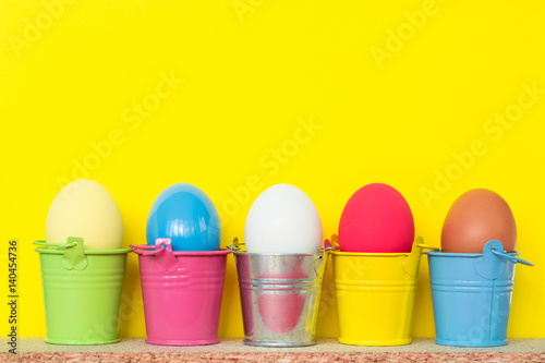 Easter eggs in colored buckets, selective focus image, Card Happy Easter 
