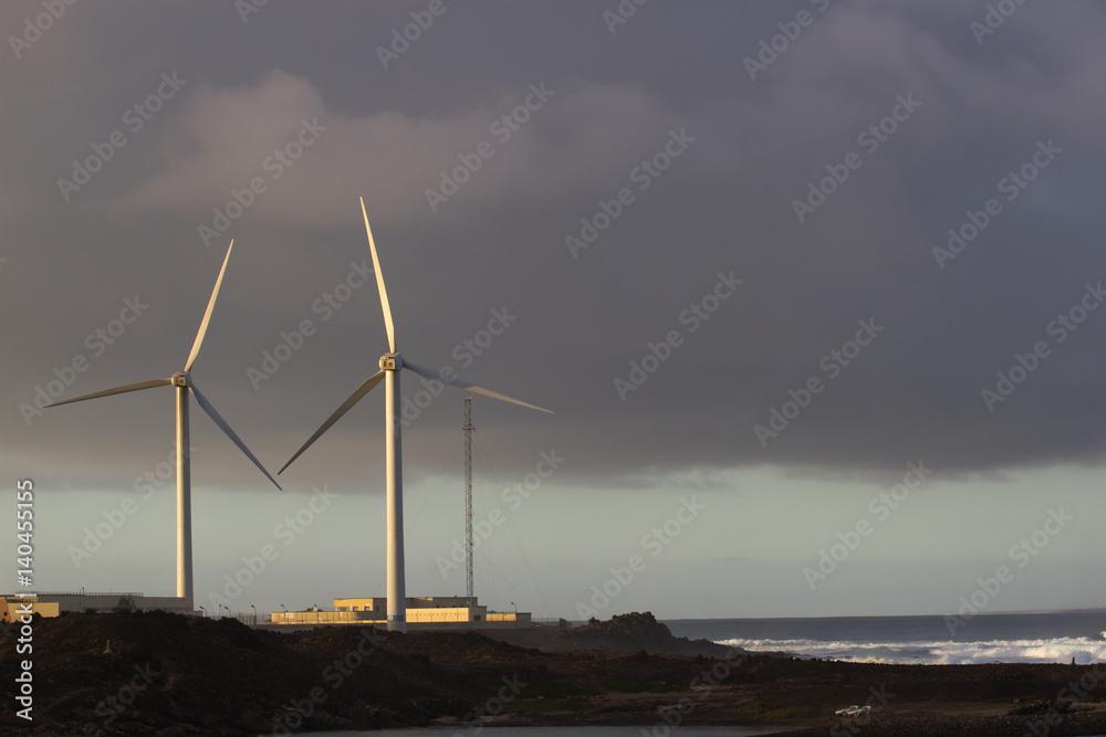 Two wind turbine move at sunset beautiful light, Spain, Fuerteventura island