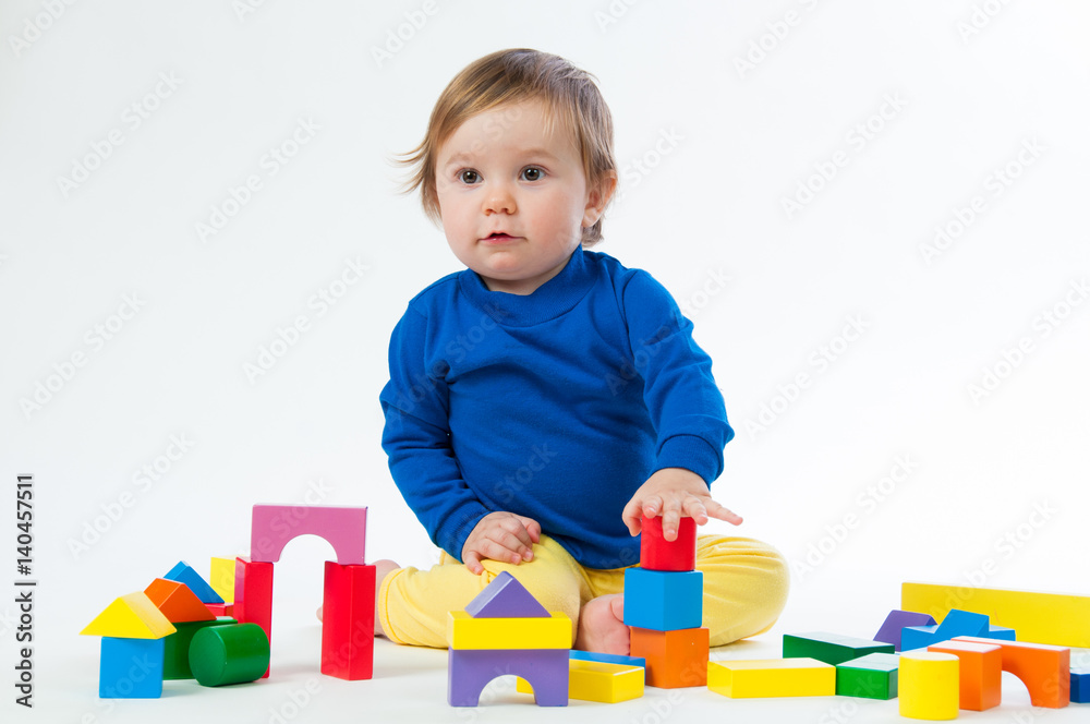 Little child playing with dices isolated on white background Little child playing with dices isolated on white background