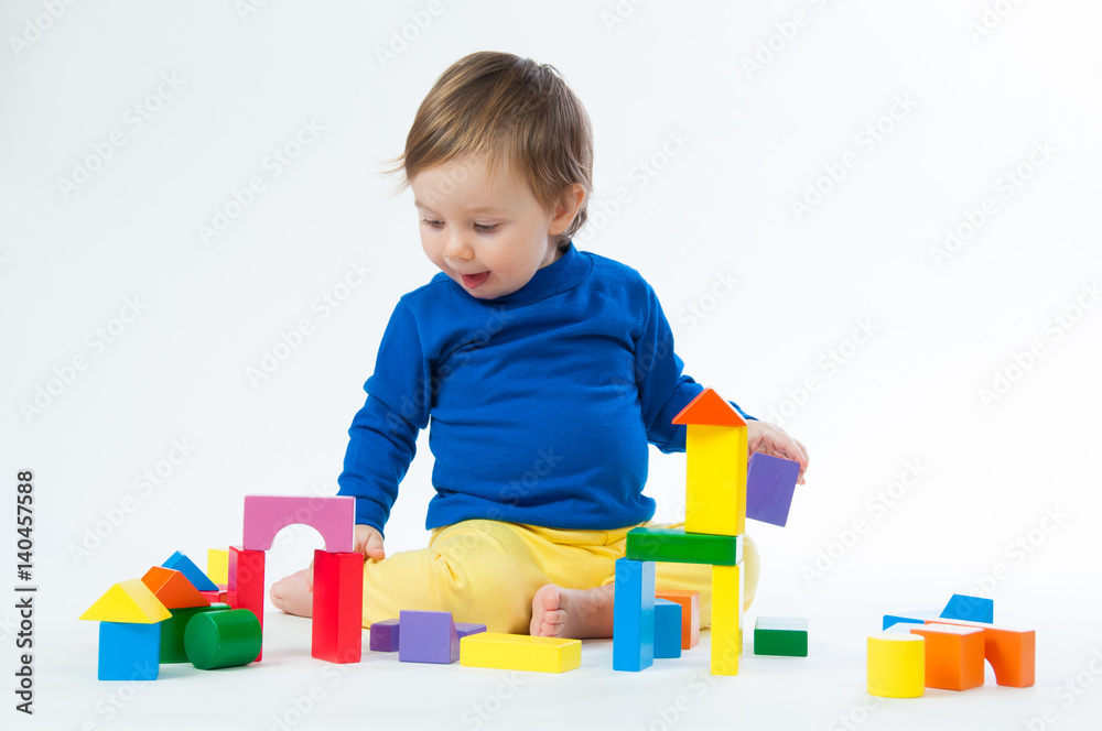 Little child playing with dices isolated on white background Little child playing with dices isolated on white background