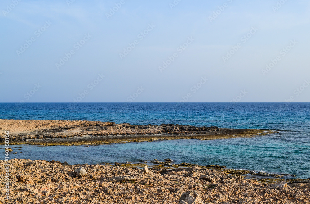 The sea view. And the shore is covered with sharp coastal stones. The sea view. And the shore is covered with sharp coastal stones.